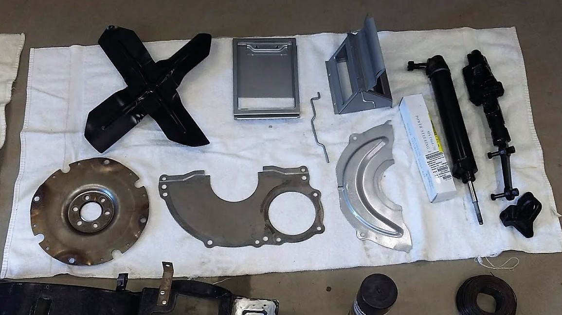 Various parts and pieces after a coat of black paint. They look like new.