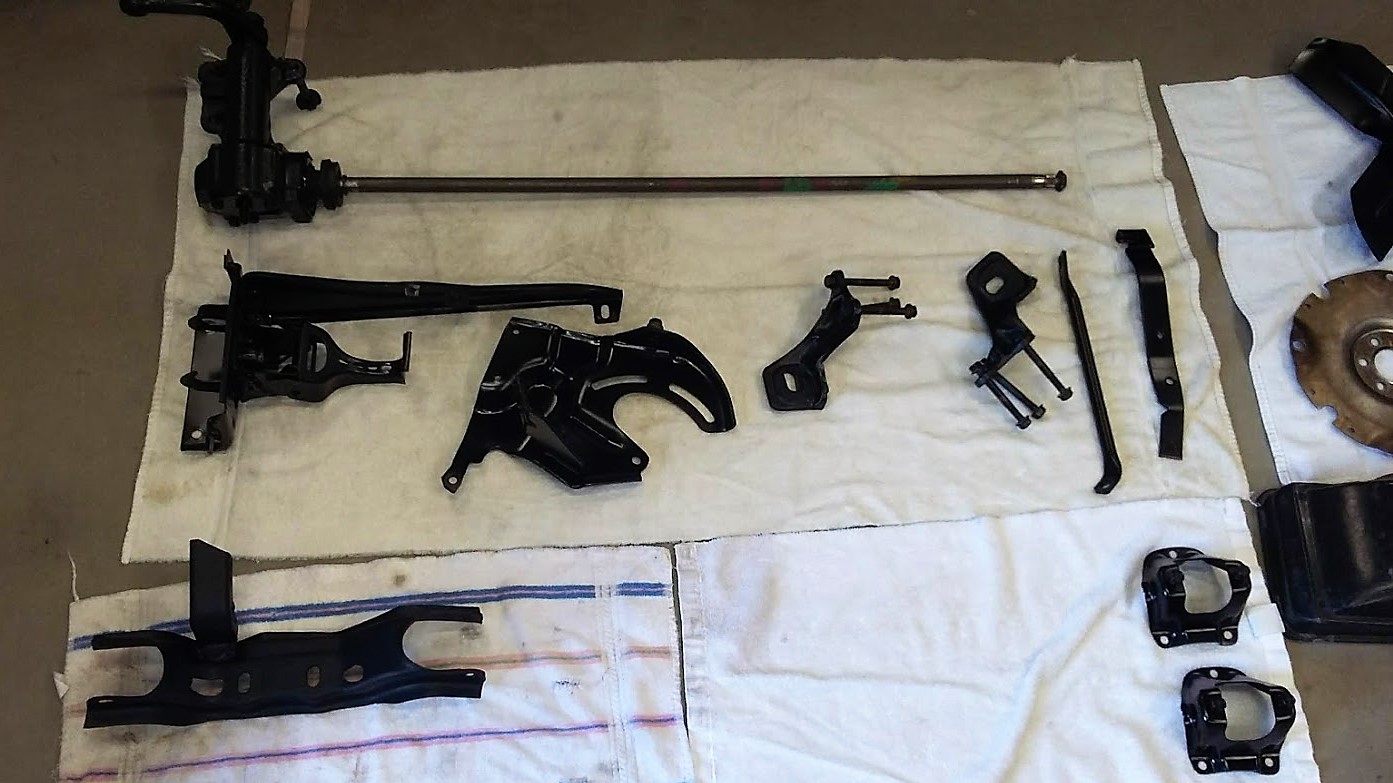 Various parts and pieces after a coat of black paint. They look like new.