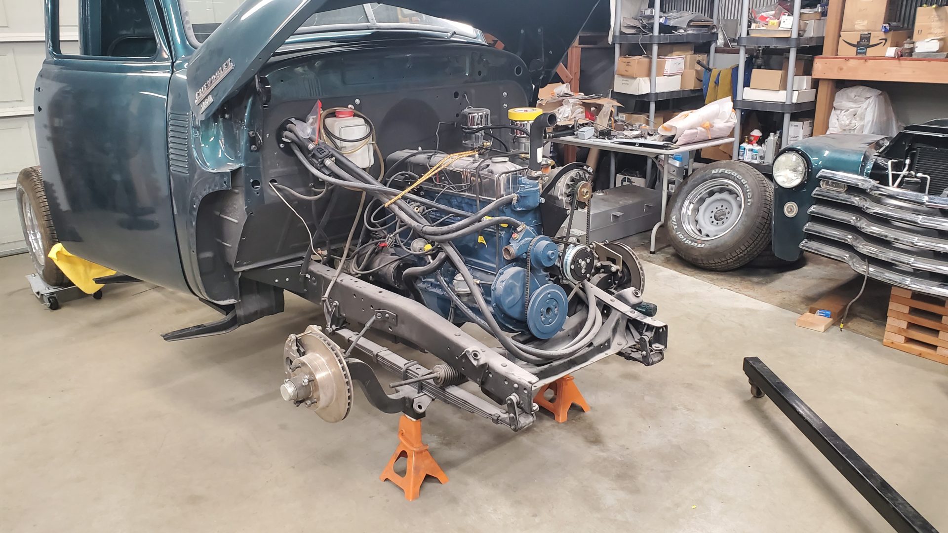 With the front clip off you can see the rack and pinion tie rods peaking out above the leaf springs and in front of the aftermarket 3" drop axle.