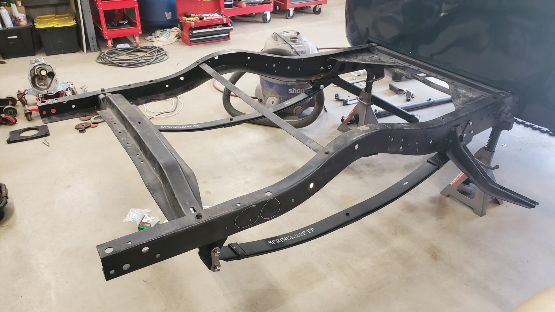 New leaf springs are hung from different hangers bolted in place