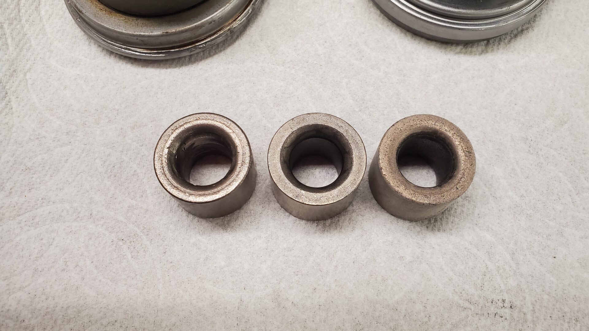 Pilot Bushings: (left) old and boogered, (middle) new but too large for this crank,and (right) Dorman bushing for 'Powerglide' crankshaft