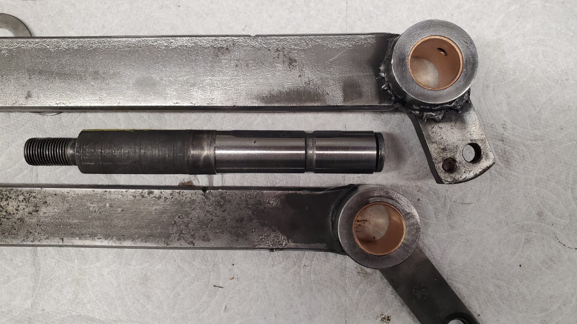 Machined pedal pivot shaft and new brass bushings.