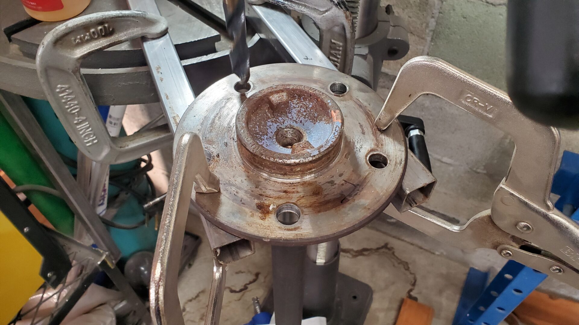 Using a drill press (for better accuracy) the axles are drilled to accept 7/16" wheel studs. The knurl on the new studs are larger. The holes need to be opened up to just the right size - not too big or too small. 35/64" is right on the money,.