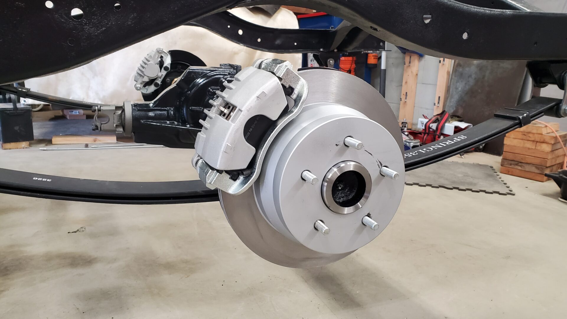 Axle shafts, rotors, and new disc brake calipers and pads go on.