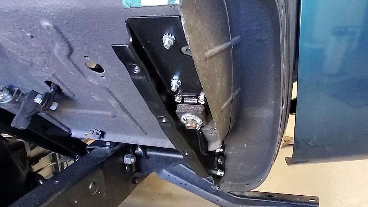 The parking brake mechanism is fully assembled on the firewall and inside the cab.