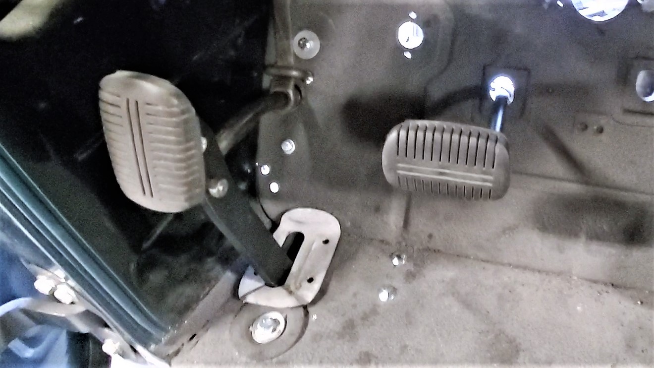 The parking brake pedal comes through the floor and uses a clever lock and and release mechanism.